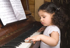 Little girl hand piano keyboard.