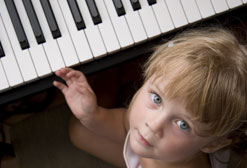 Little boy hand piano keyboard.
